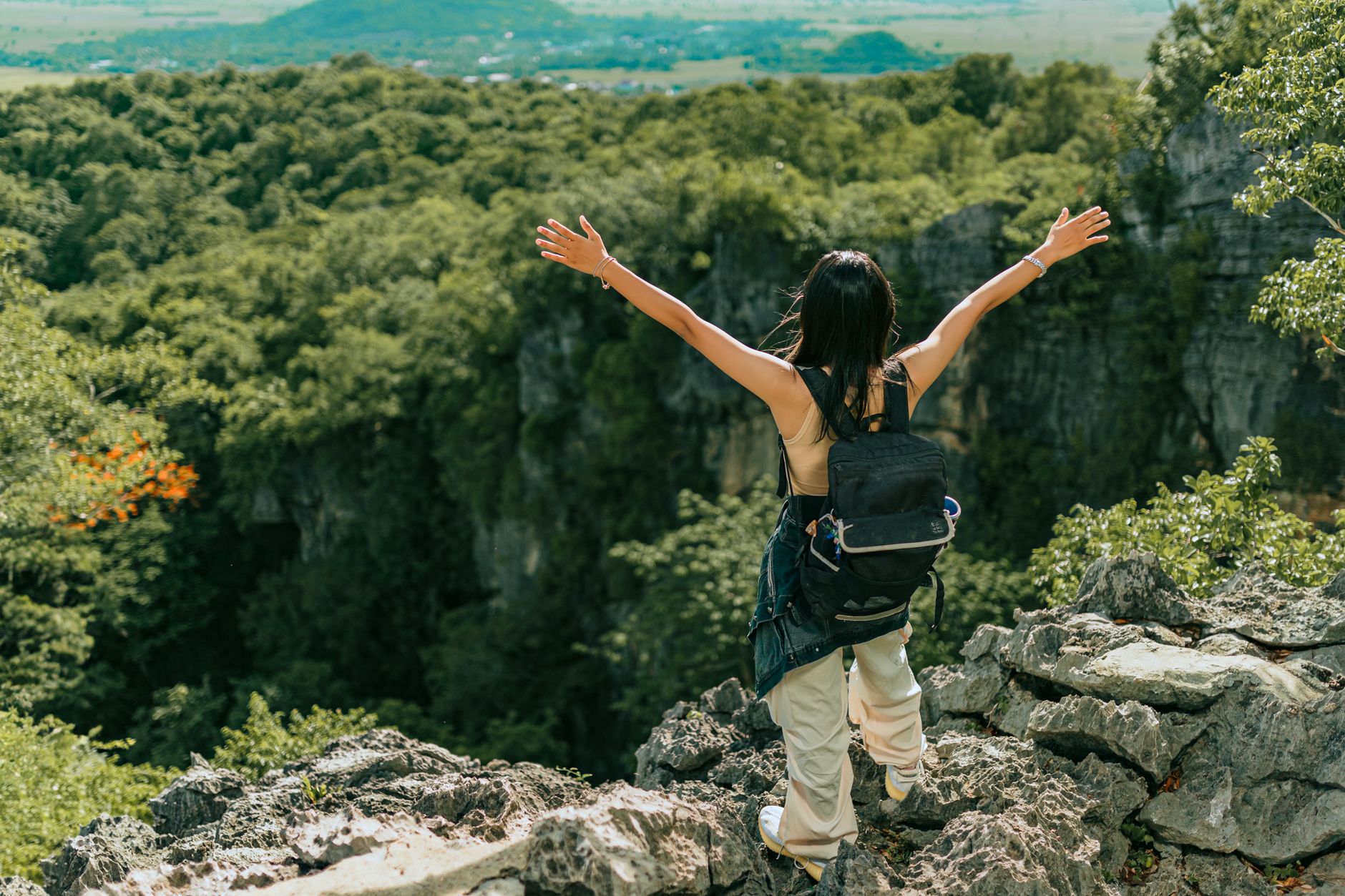 Hiker wearing a sport watch while navigating a rocky mountain trail