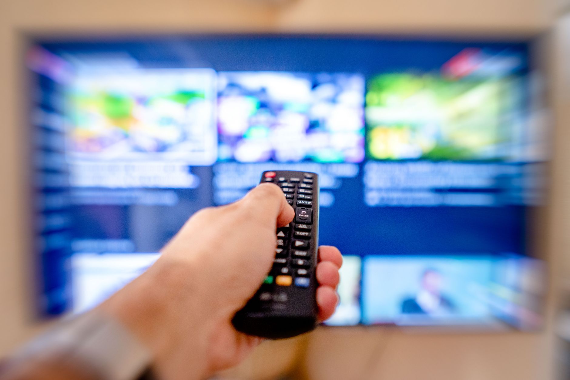 Person streaming media content on a television at home