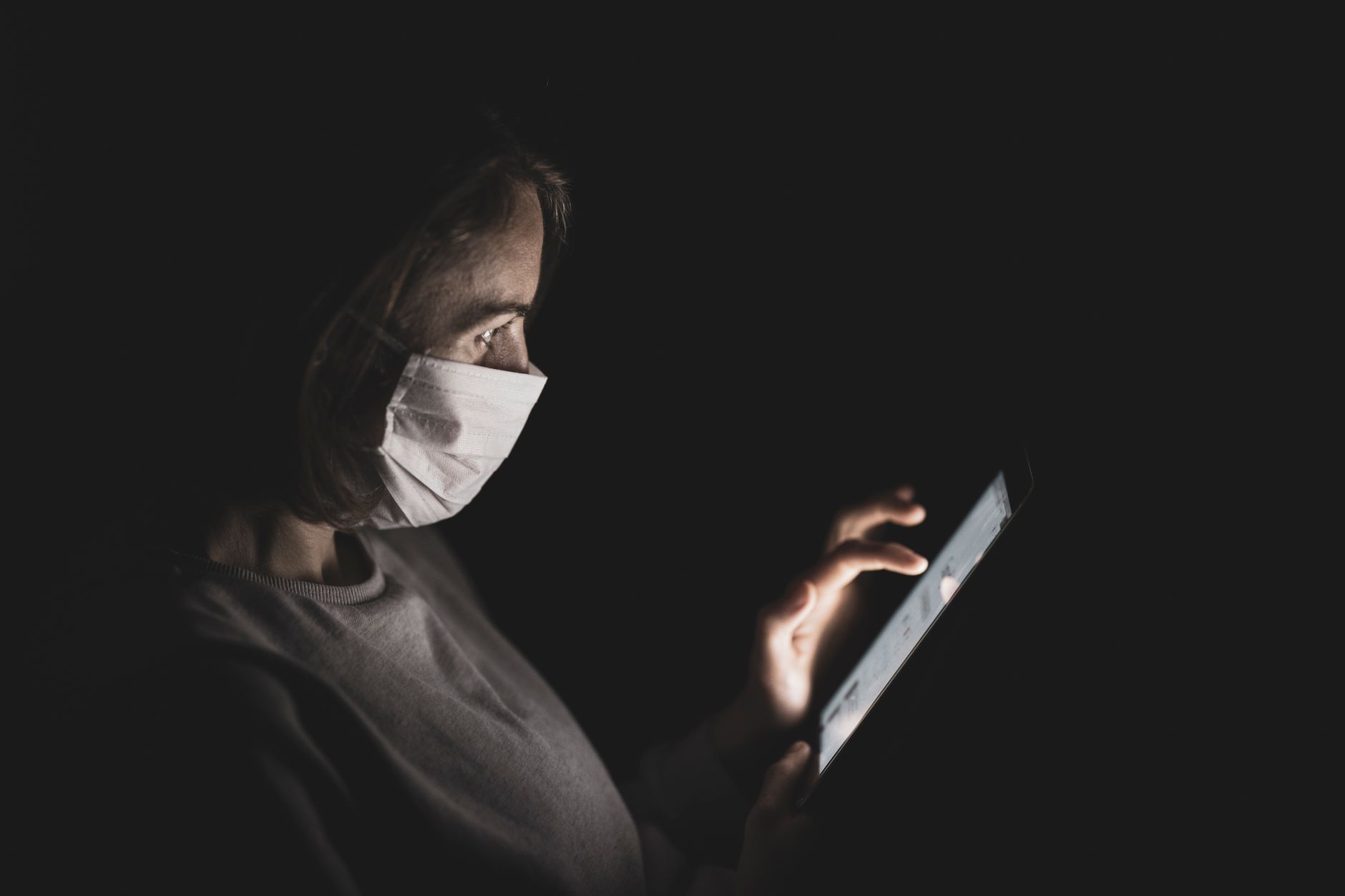 Person reading news articles on a tablet device at a desk