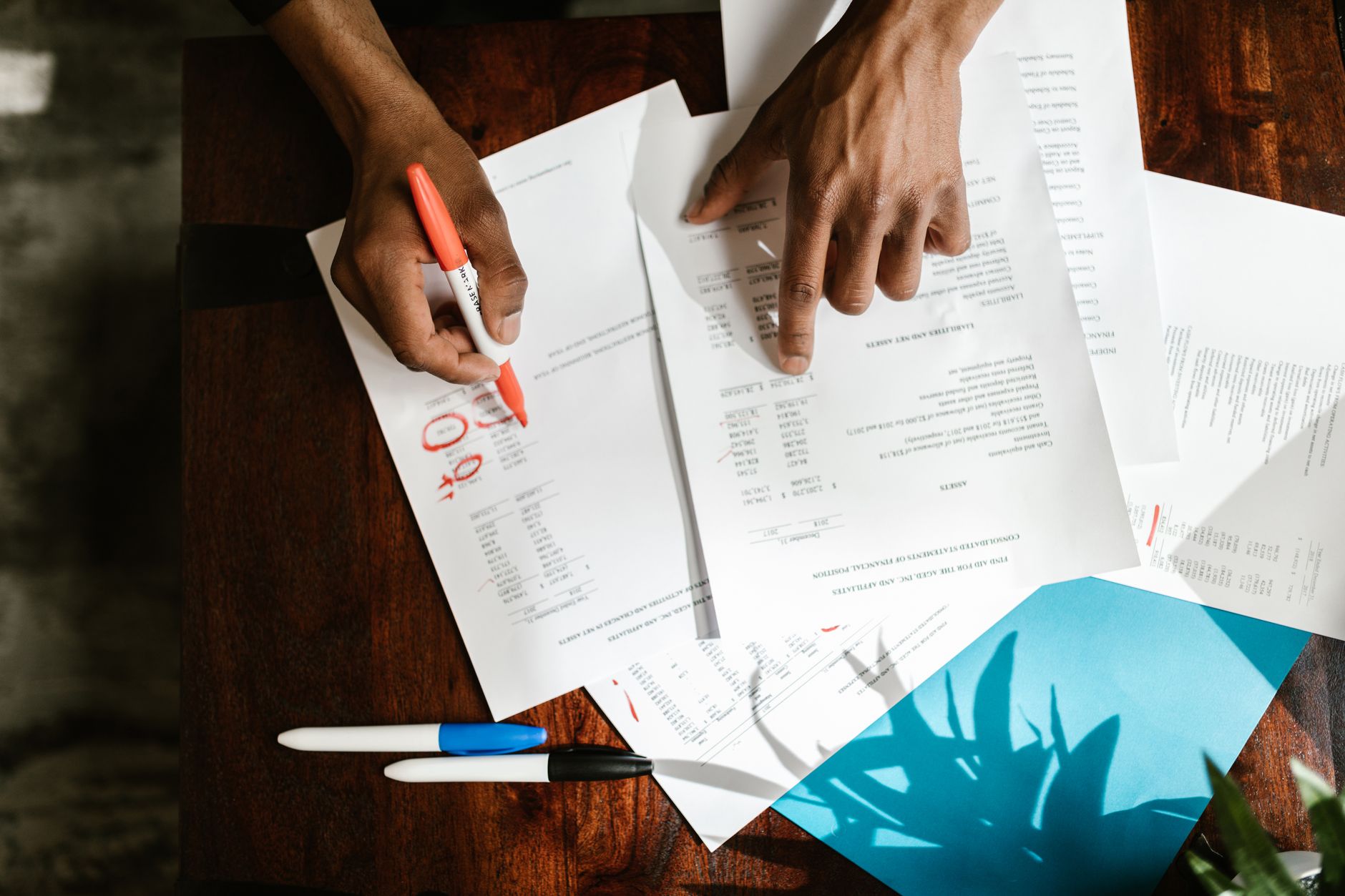 Financial report documents spread on a table representing tax filing and reporting