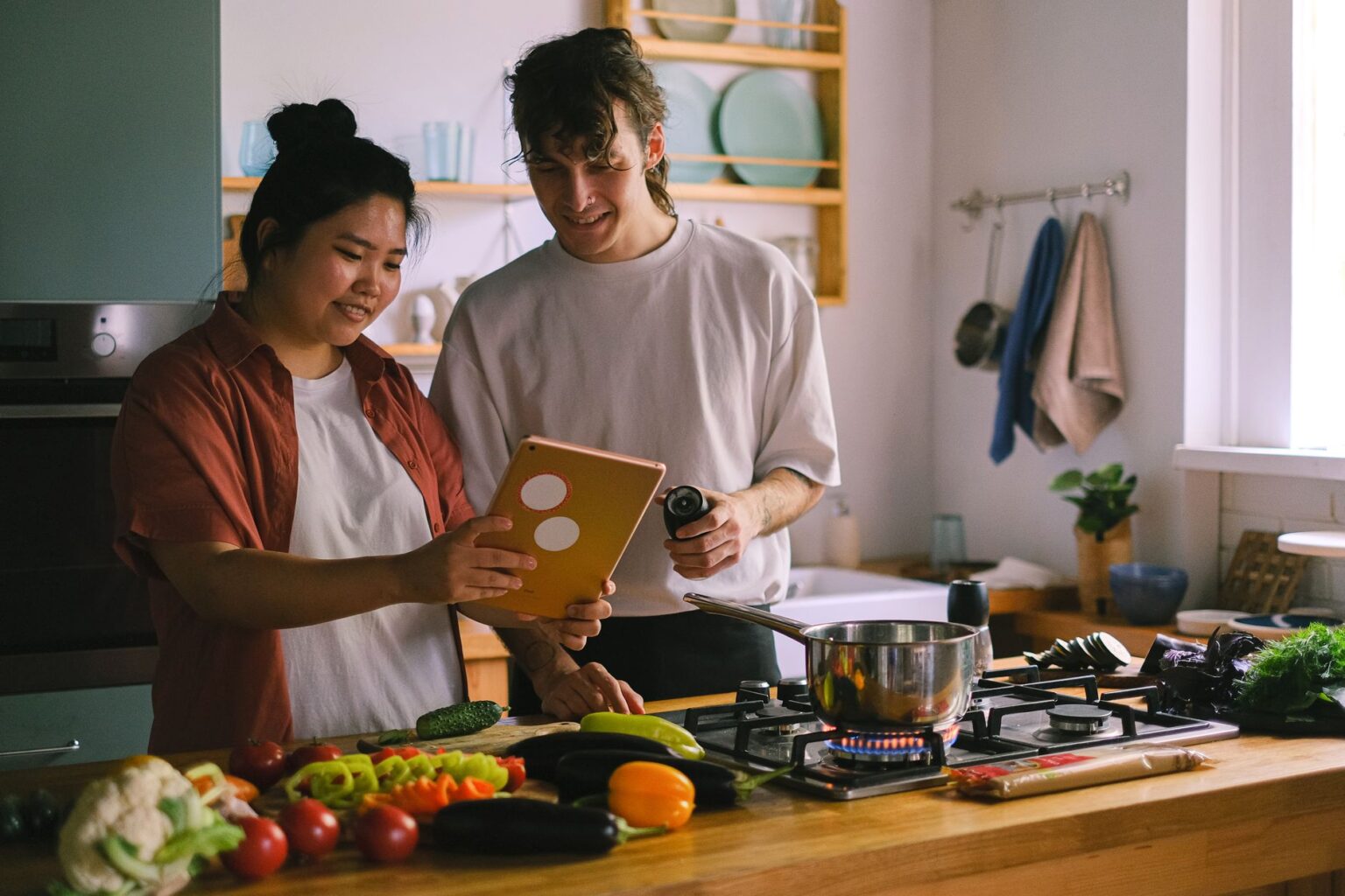 Tablet displaying a recipe app on a kitchen counter next to fresh ingredients