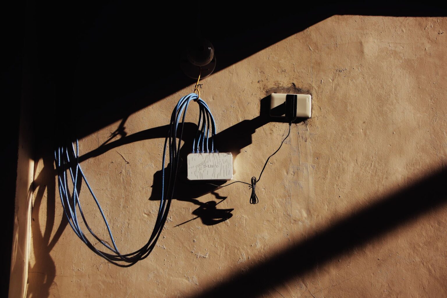 A home Wi-Fi router on a desk representing network DNS configuration