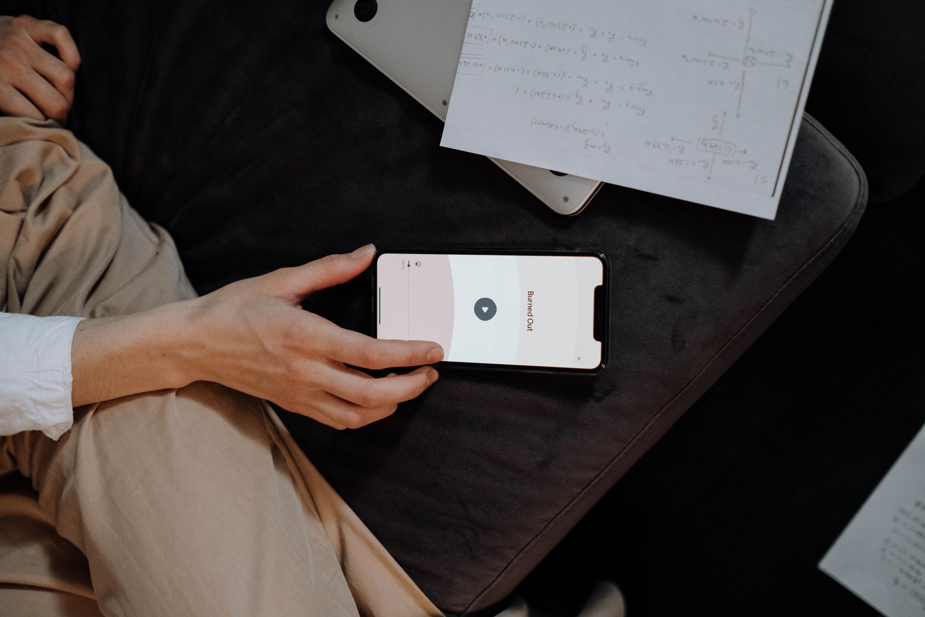 A person reading news on a mobile device using an RSS reader application