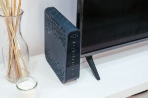 Set Up Homebridge to Connect Non-Apple Devices to HomeKit A smart home hub device sitting on a desk representing home automation setup
