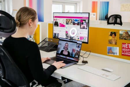 Set Up Nextcloud Talk as a Self-Hosted Video Conferencing Server Person participating in a video conference call at a desk with a laptop