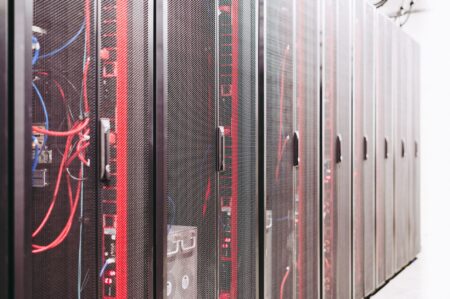 Set Up Vaultwarden as a Self-Hosted Bitwarden Password Manager A rack of servers in a data center representing self-hosted infrastructure