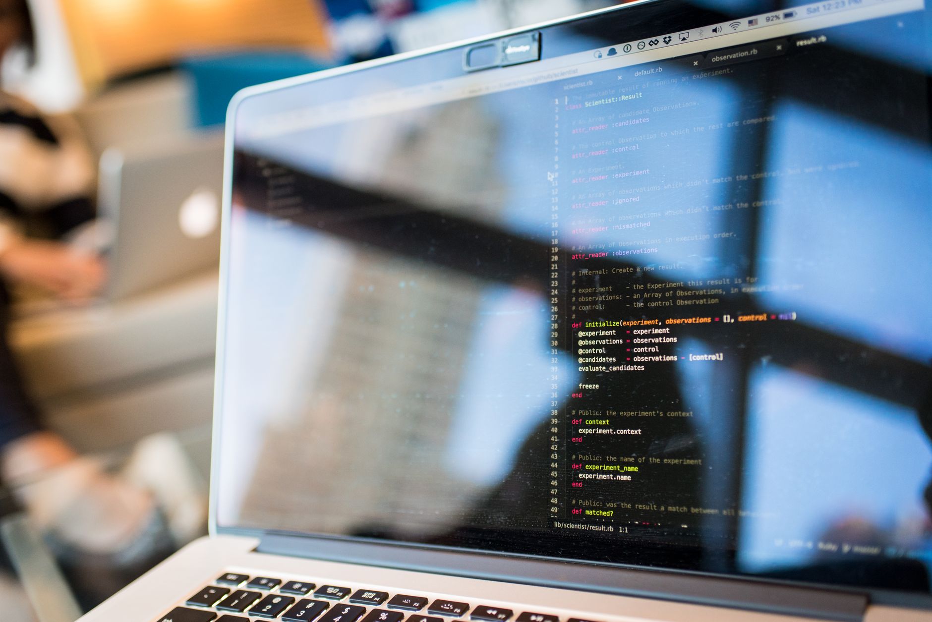 Developer working on a laptop with code on screen for web application deployment