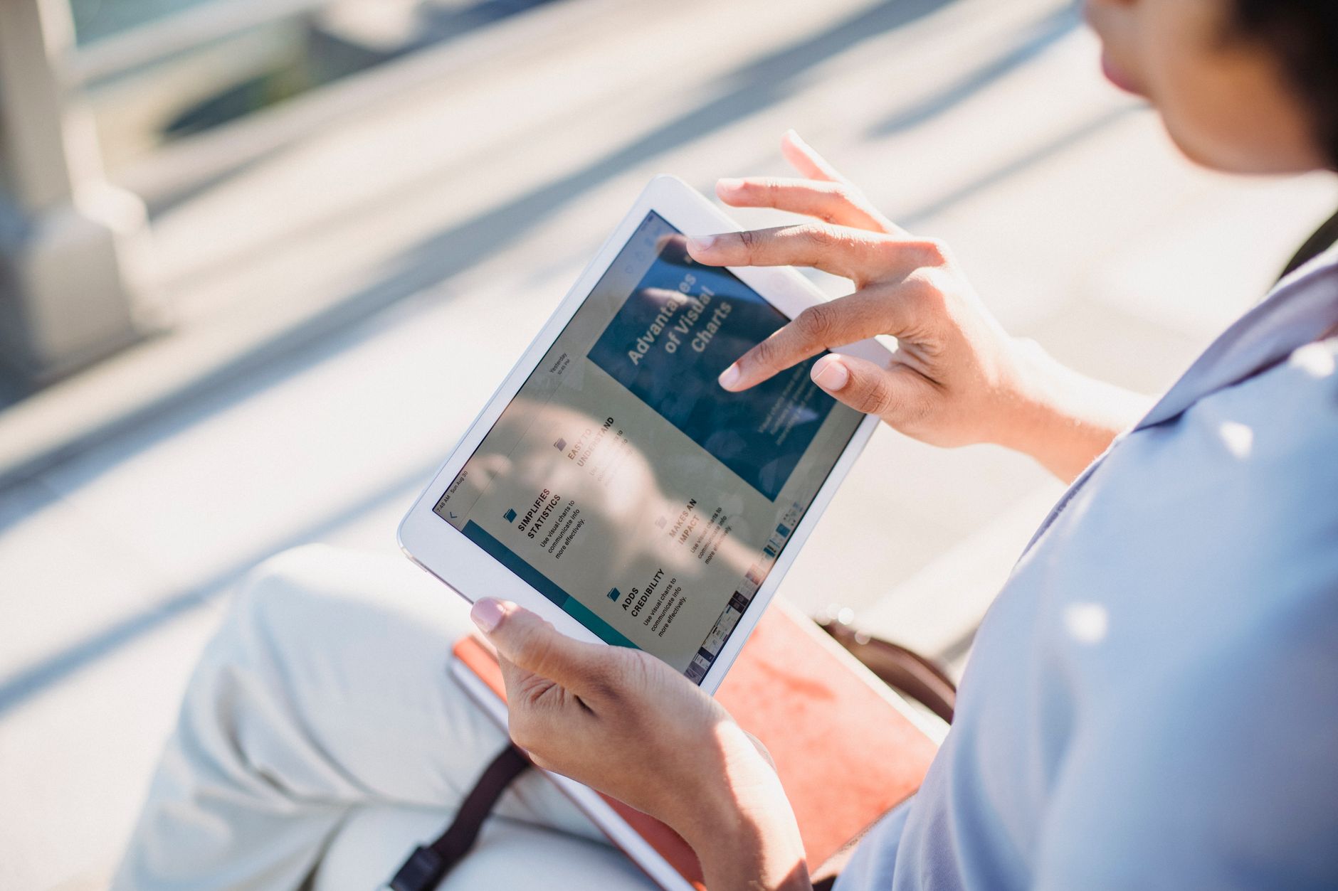 Person reading news articles on a tablet device