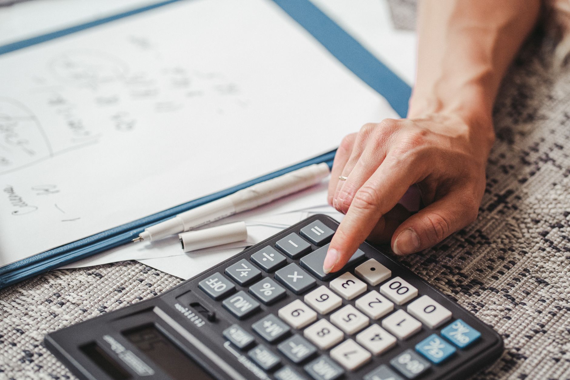 Budget planning spreadsheet on a laptop screen showing financial categories