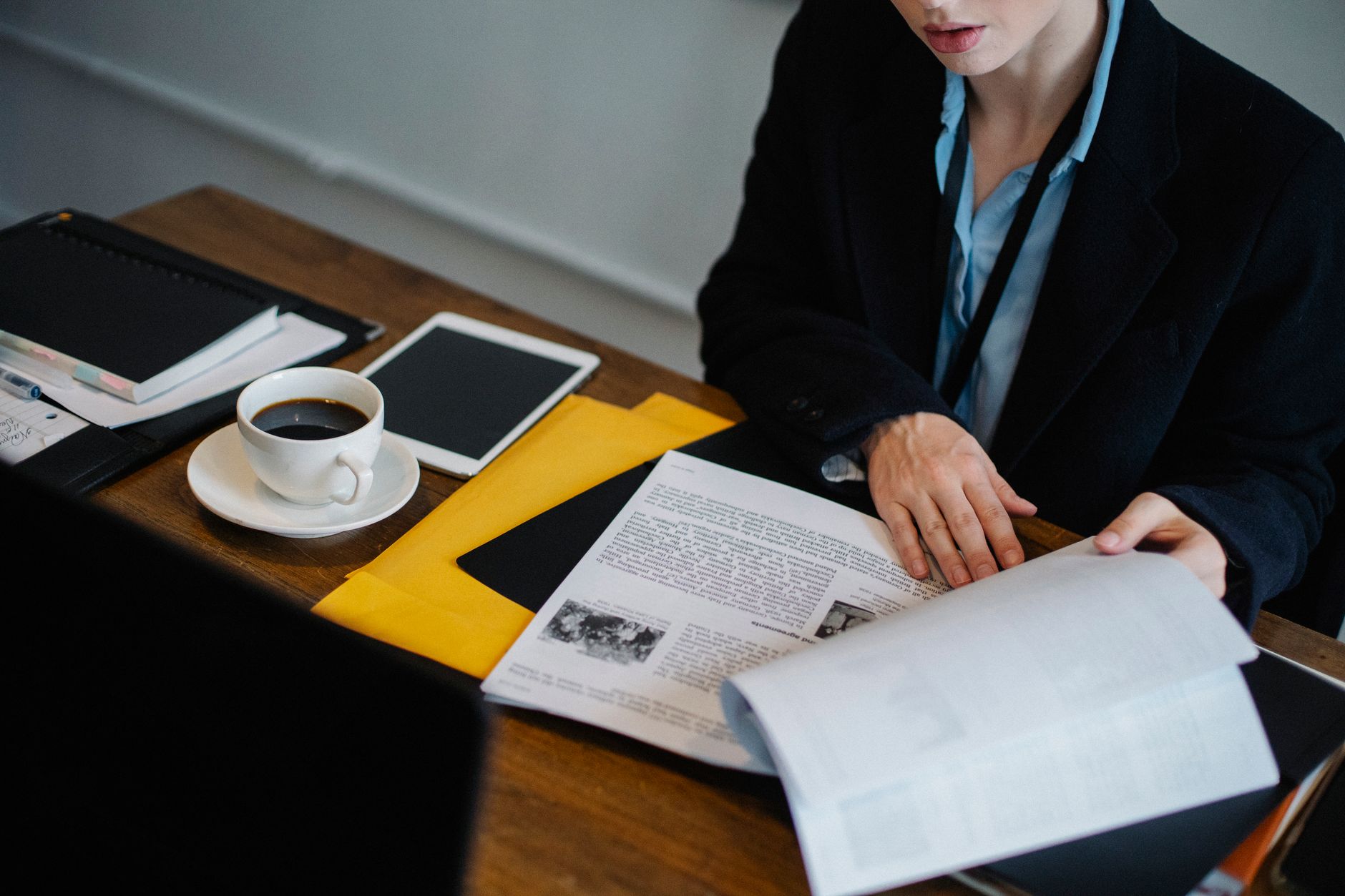 A stack of PDF documents on a desk representing document management