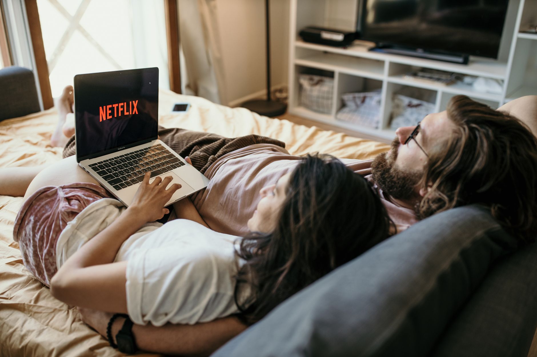 A television screen showing a movie streaming library interface in a home setting