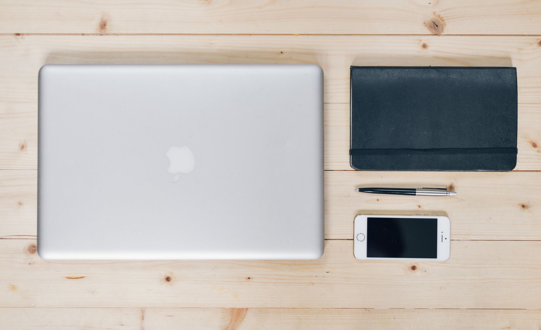 A person working on a laptop at a clean productivity desk setup