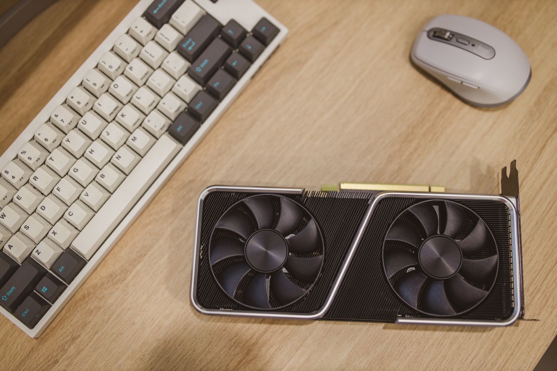 Close-up of a laptop and graphics card hardware on a workbench