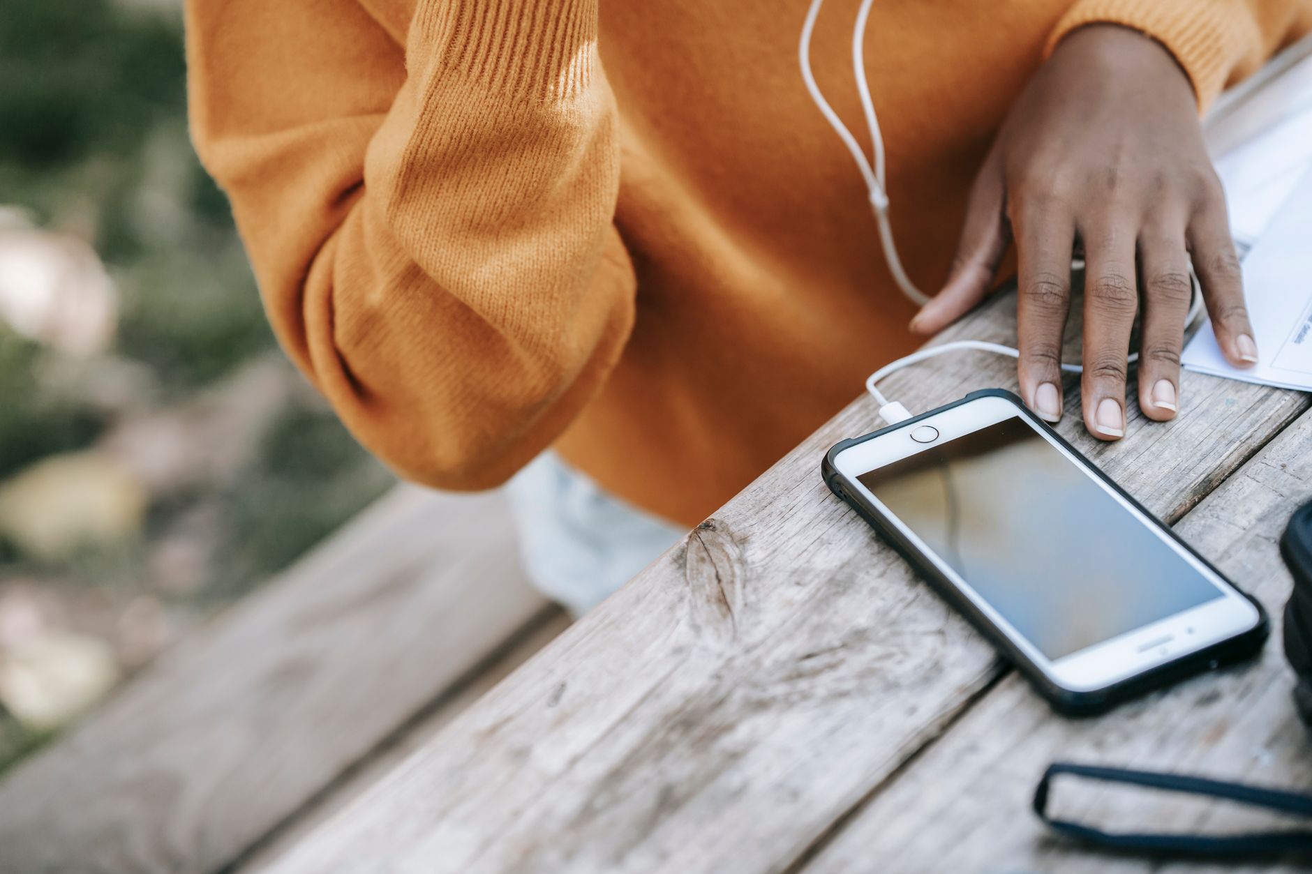 A person using a smartphone app to stream music from a personal library