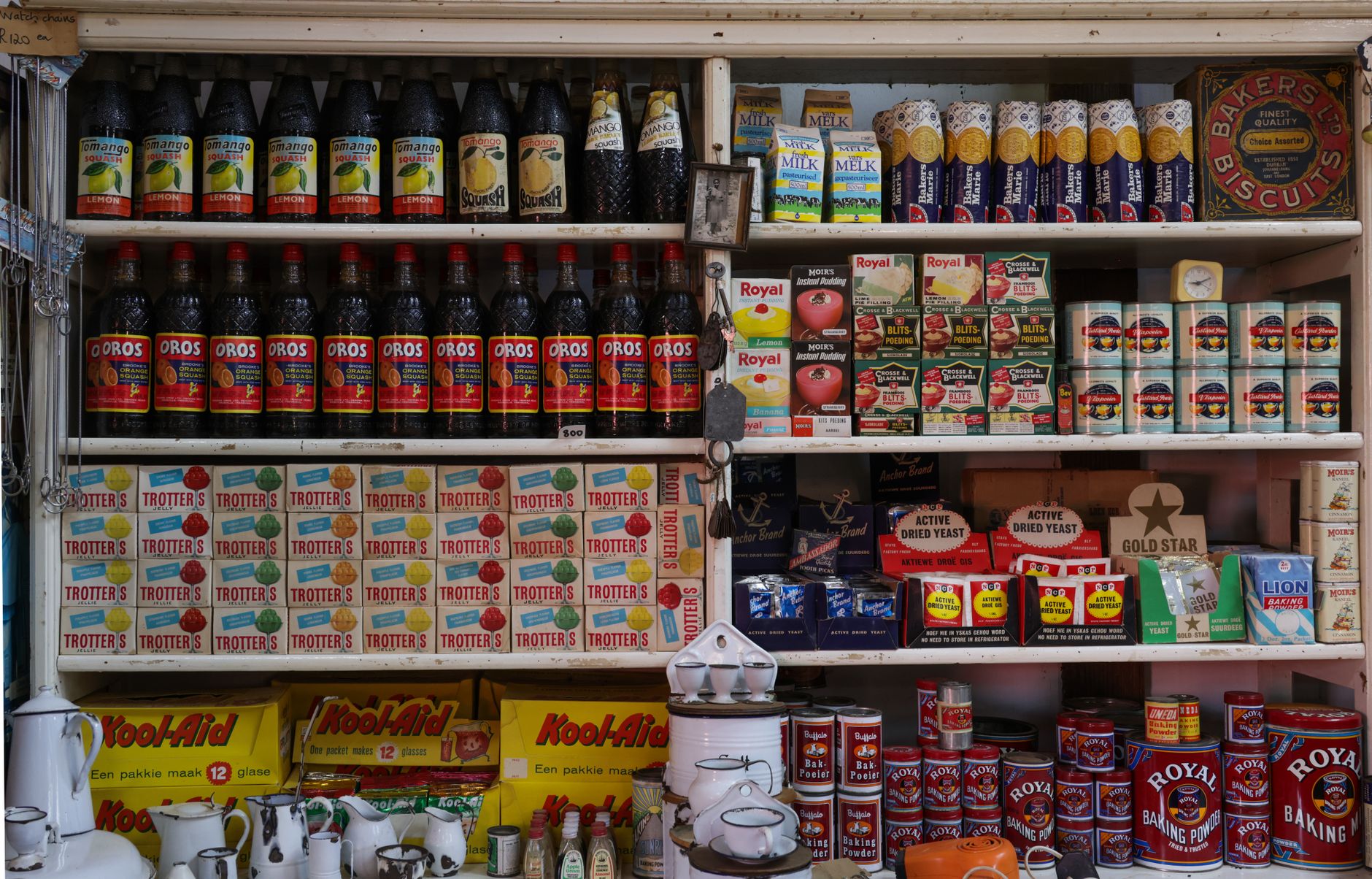 Organized pantry shelves with labeled food containers and canned goods