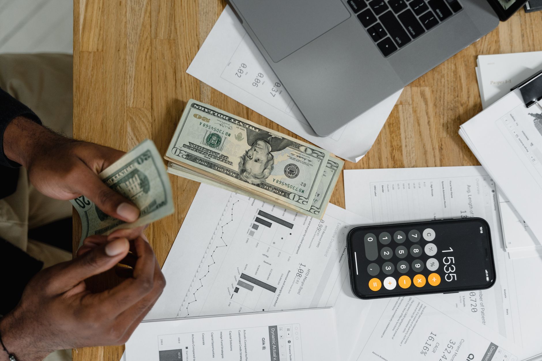 Person reviewing a budget spreadsheet at a desk