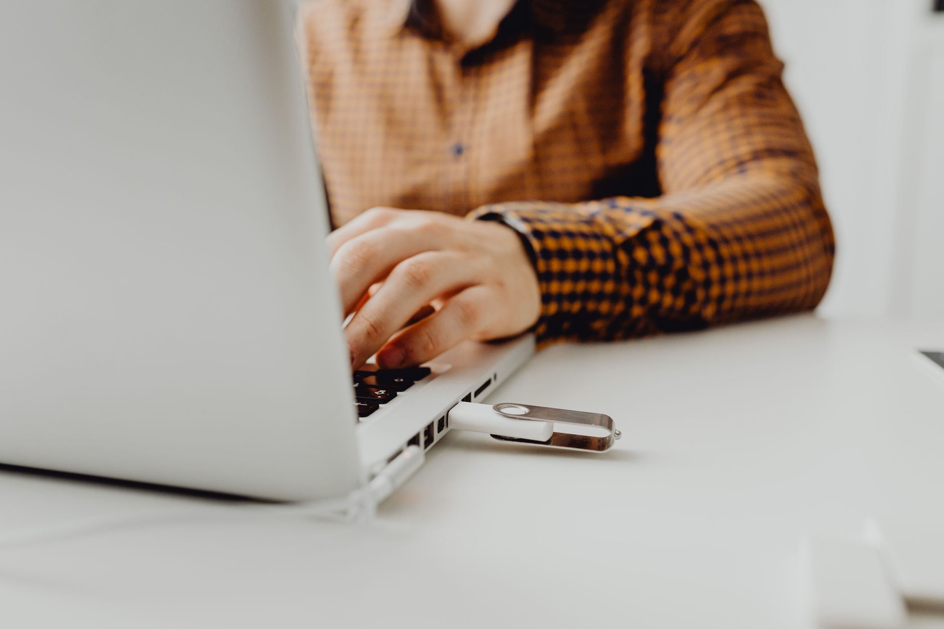 Two laptops side by side representing peer-to-peer file synchronization between devices