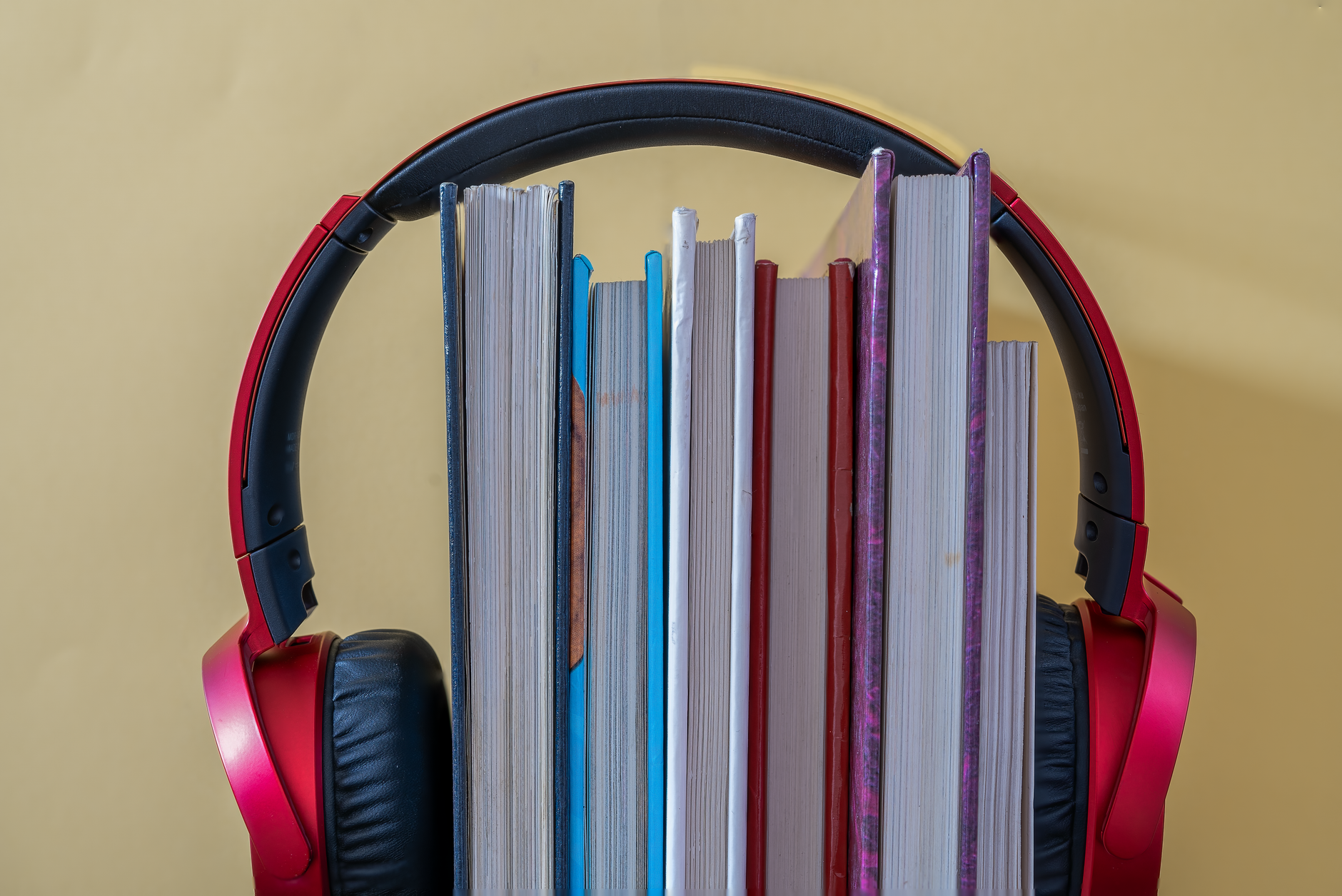 Person using a tablet to listen to an audiobook with headphones