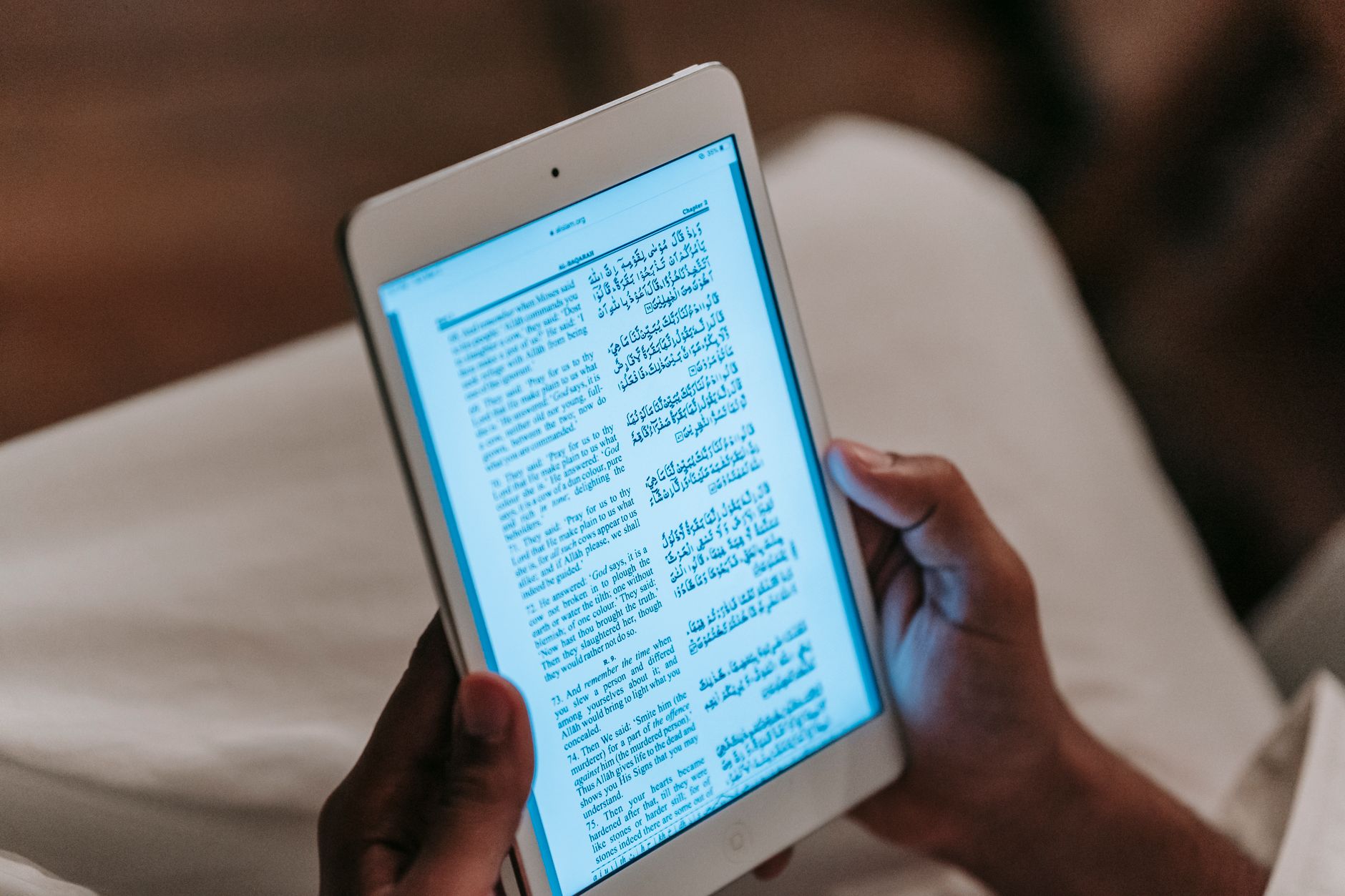 A person reading on an e-reader tablet connected to a personal book server
